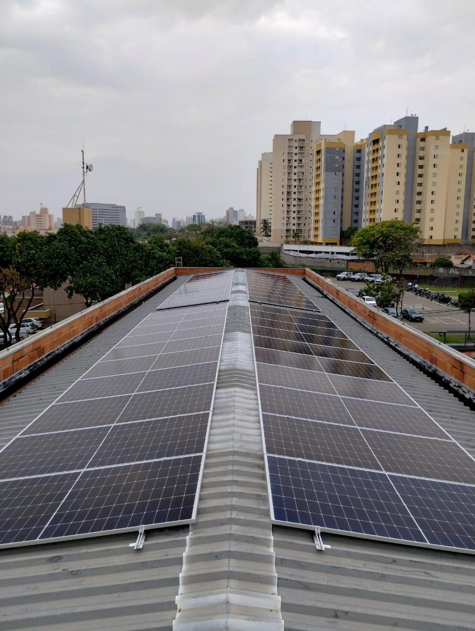 Grande usina solar cobrindo o telhado de galpão comercial